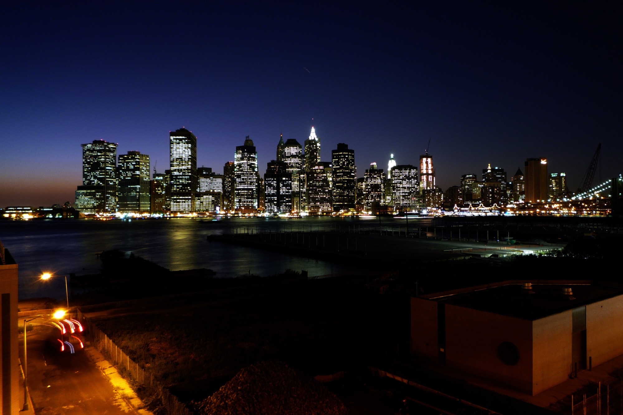 A city skyline across the water at blue hour